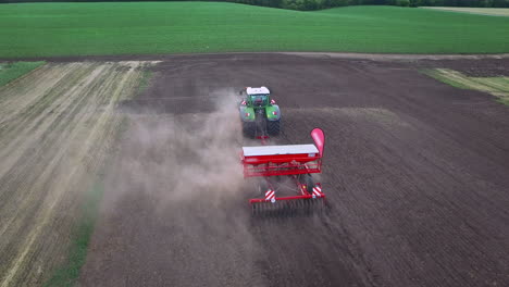 sowing machine working on plowed field. agricultural machinery