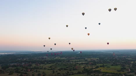 aerial shot of hot-air balloons taking off at sunrise, bagan, myanmar