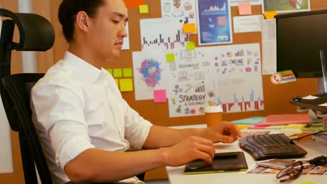 graphic designer using graphic tablet at desk