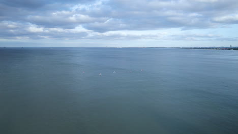 Drone-view-of-group-on-stand-up-paddle-board-at-sea