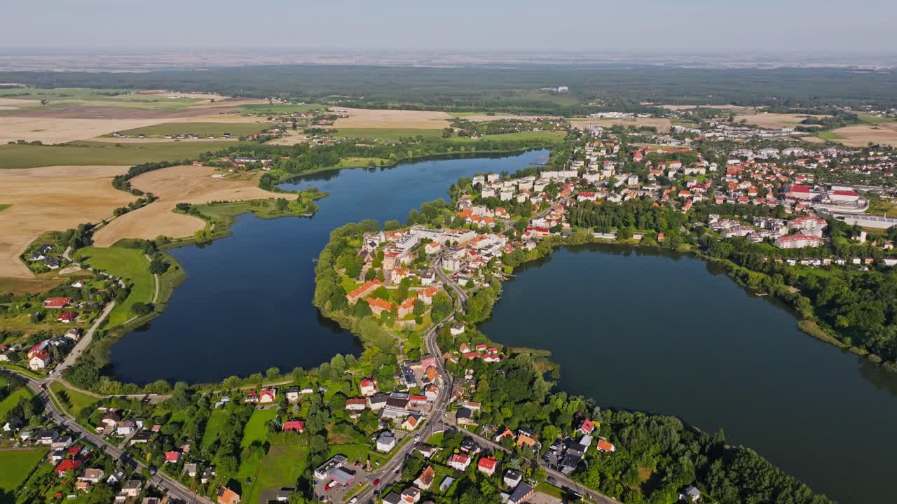Aerial establishing shot of Sztum Poland, city streets meet surrounding forest