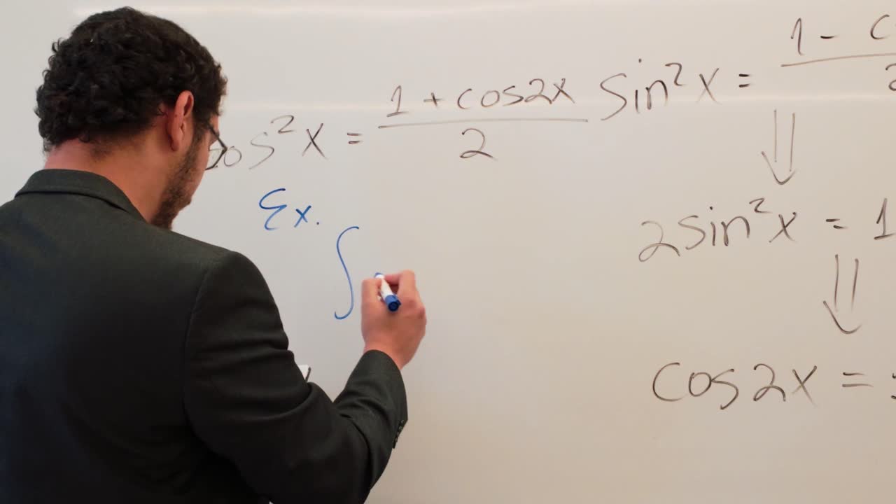 Man Writing a Trigonometric Identity on a Board