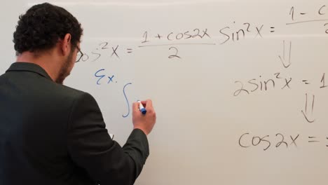 man writing a trigonometric identity on a board