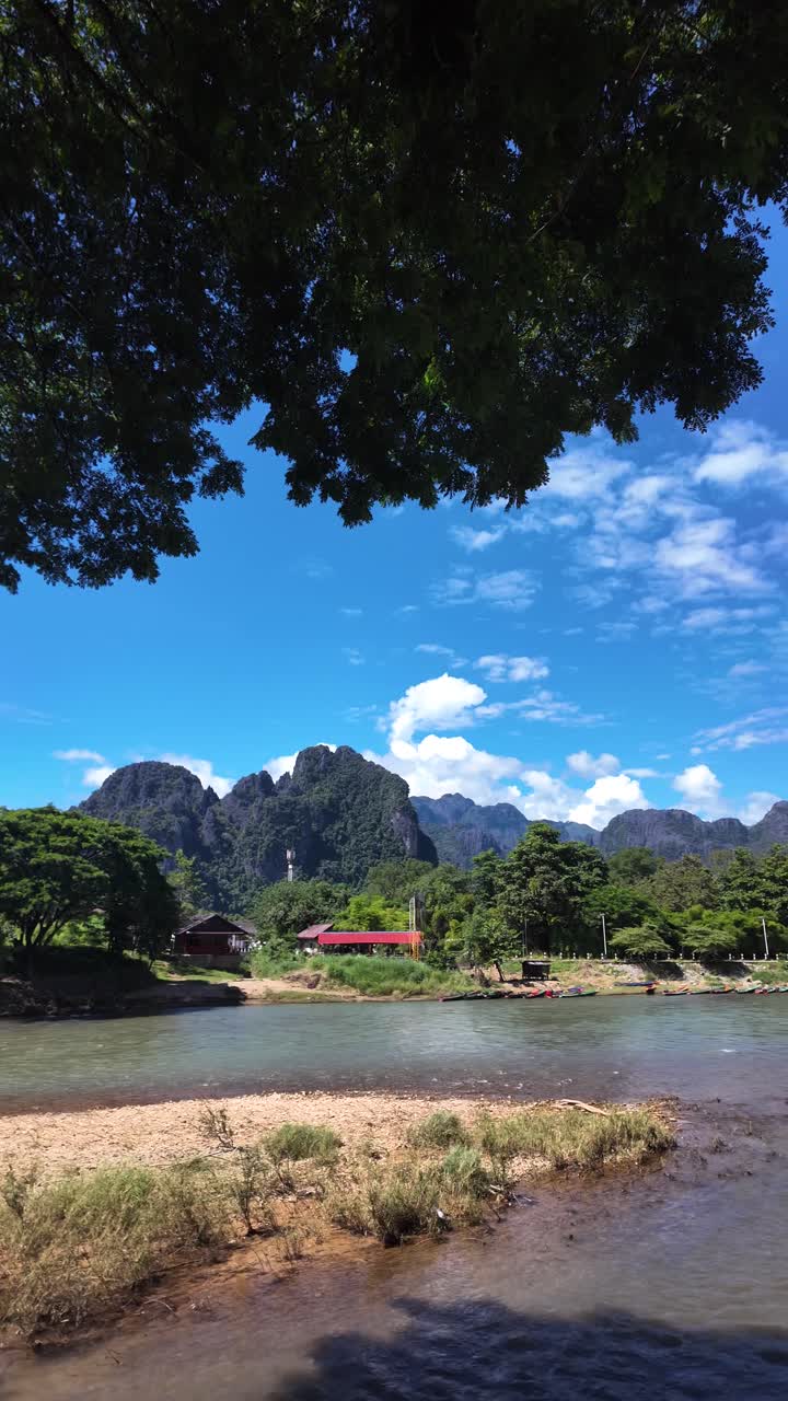 Scenic Vang Vieng Laos Landscape With Nam Song River Karst Limestone Mountains Blue Sky And Clouds On Sunny Day. Vertical video