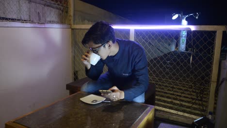 portrait of an asian man working late at a cafe