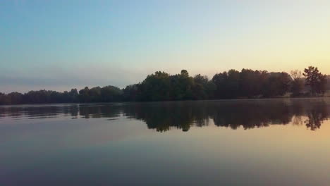 Aerial-shot-of-a-sunrise-over-a-lake