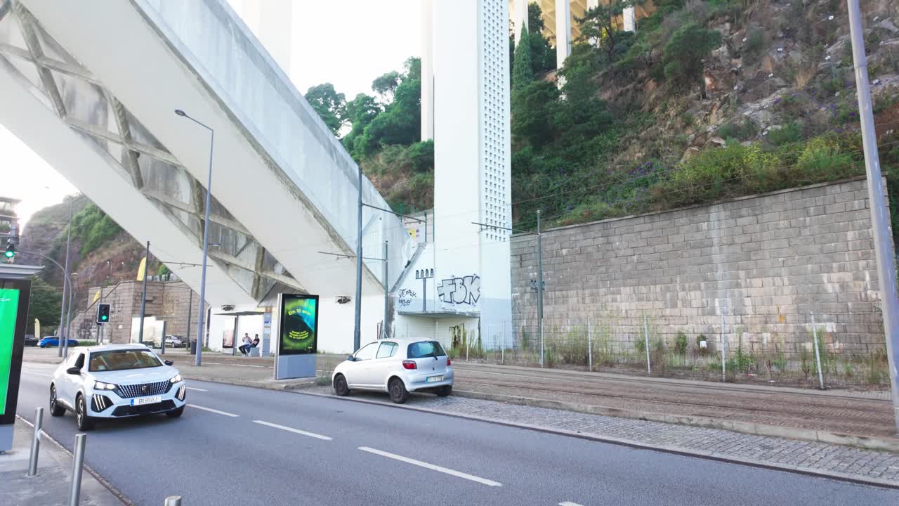 Looking up at the towering Arrábida Bridge from below on a bright sunny day