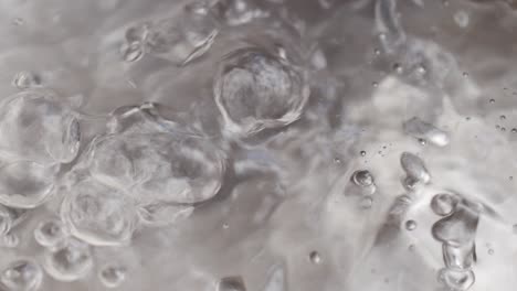 boiling water with bubbles in pan