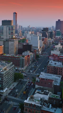 diverse architecture of beautiful new york. broad street with cars moving along. wonderful pink sky background. vertical video