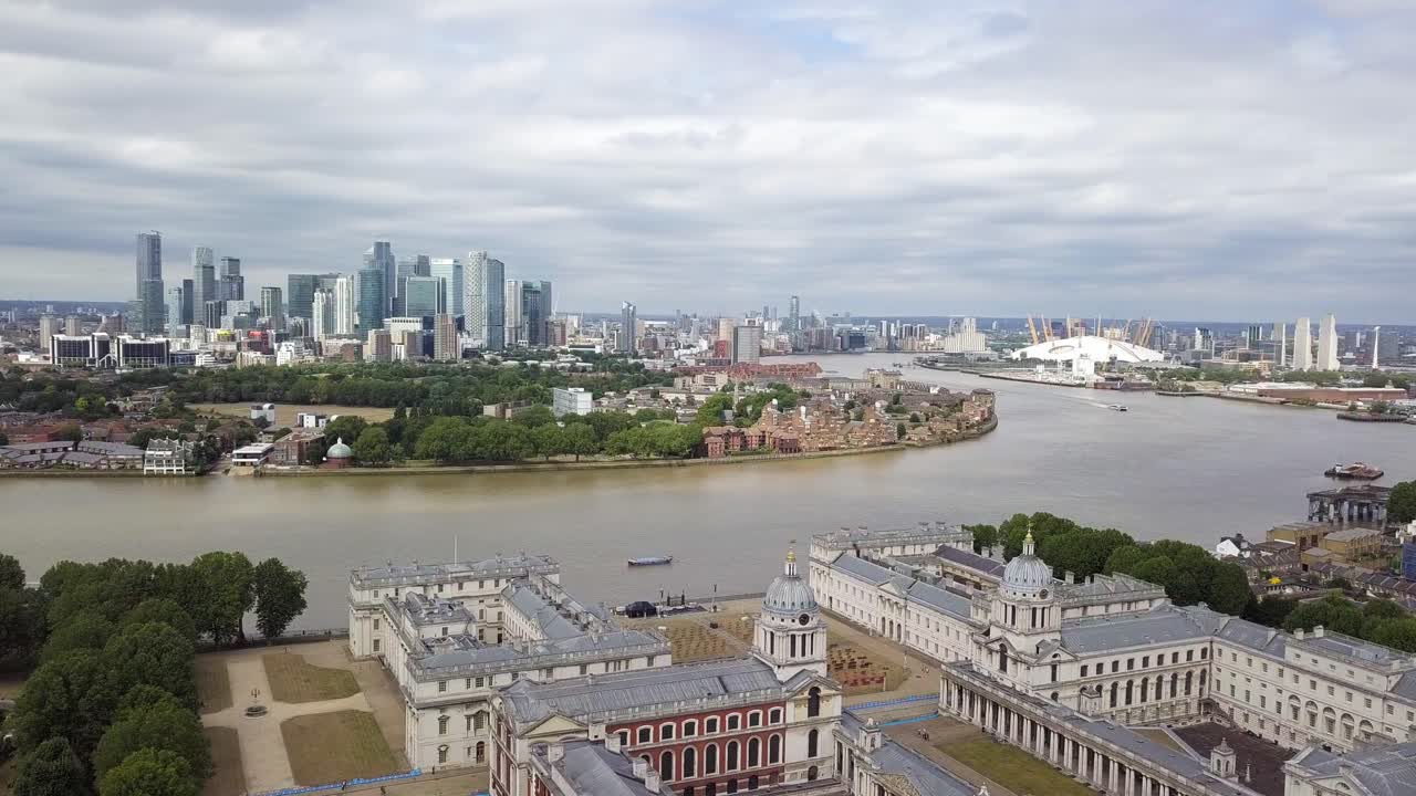 An aerial drone parralax view of isle of dogs from Greenwich observatory park in cloudy grey weather