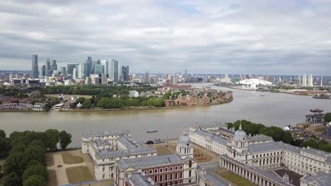 an aerial drone parralax view of isle of dogs from greenwich observatory park in cloudy grey weather