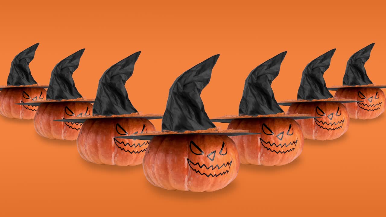 seamless looping animation with many orange pumpkins. scary smile and black witch hat rotating close-up. creative halloween concept on background with copy space