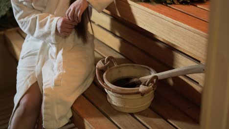 young woman having rest in sauna alone