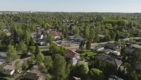 aerial tracking shot of a construction site in middle of a suburban neighborhood