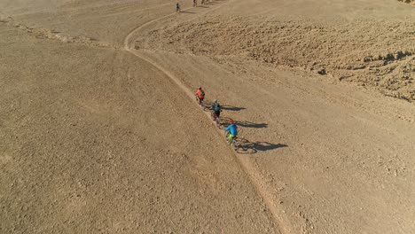 Aerial-footage-of-a-group-of-bicycle-riders-riding-on-bike-trails-in-the-desert