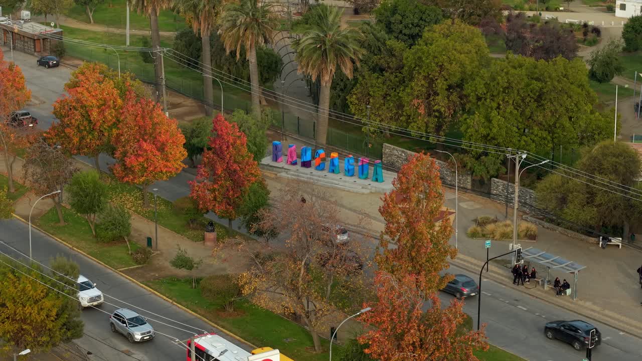 Aerial orbit of the Rancagua sign, city south of Santiago, Bernardo O'Higgins Region, Chile, trees in autumn