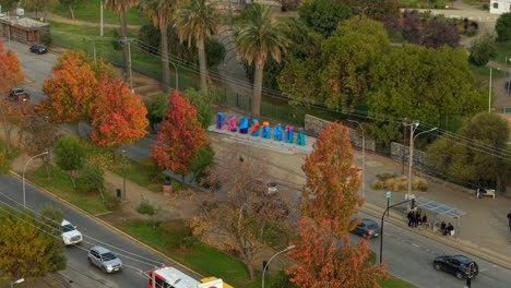 aerial orbit of the rancagua sign, city south of santiago, bernardo o'higgins region, chile, trees in autumn
