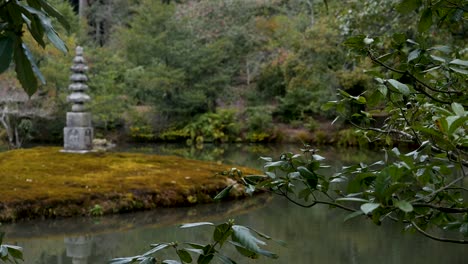 still shot of tranquil pond with statue temple tourist sight in kyoto japan 1920x1080 hd