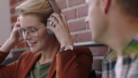 happy business people relaxing on lunchbreak caucasian businessman sharing headphones female colleague smiling flirting enjoying office romance listening to music