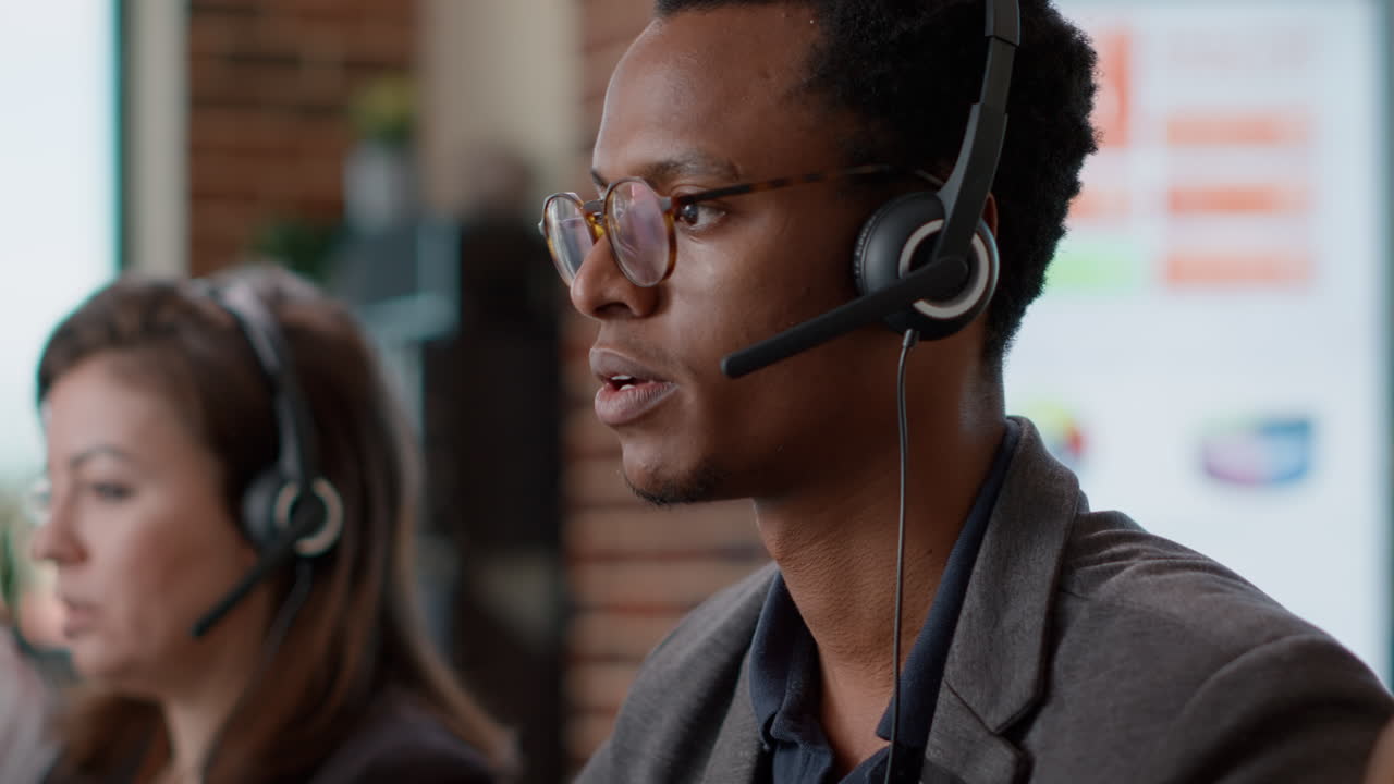 African american worker having conversation on headset with client
