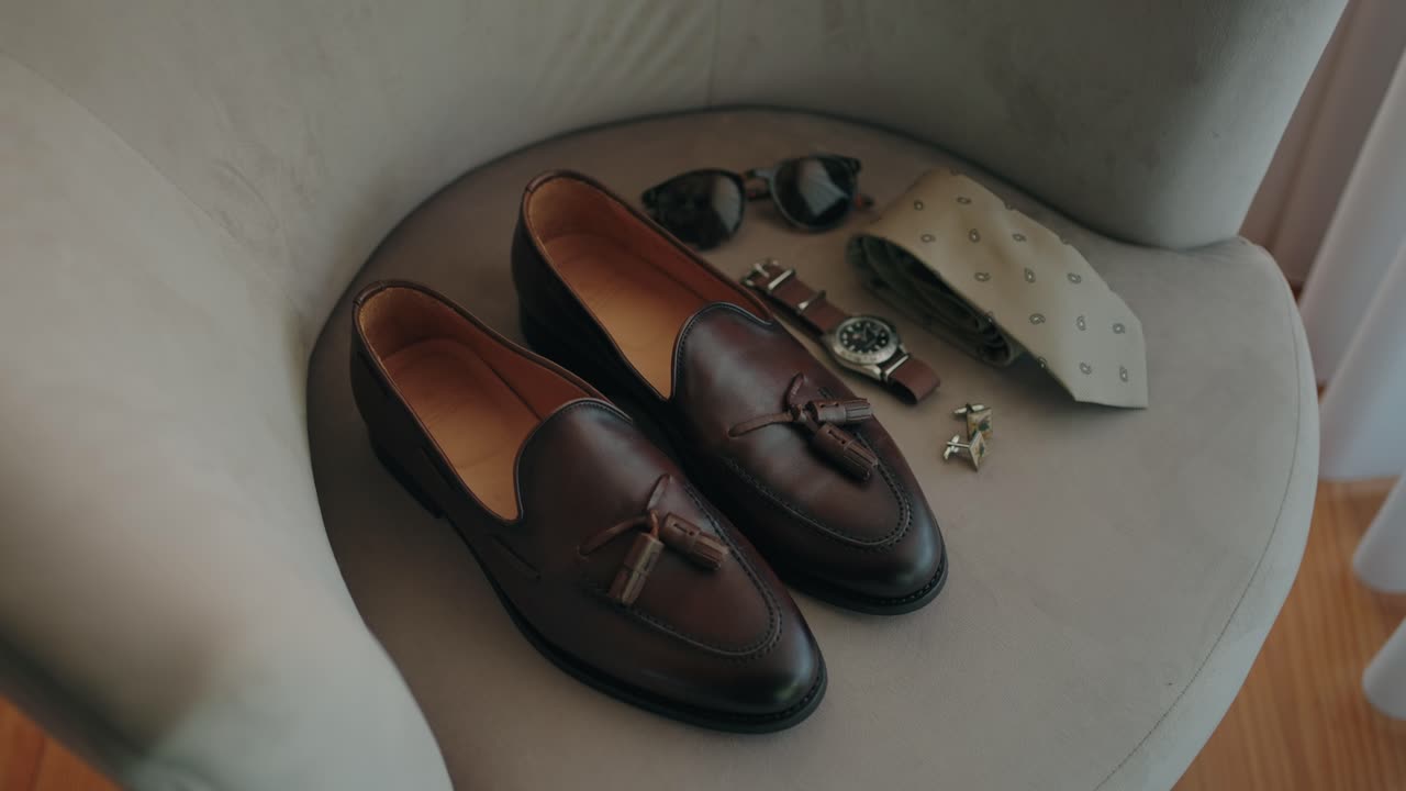 leather shoes tie watch sunglasses and cufflinks set on chair