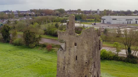 srah castle tower upper half with decrepit walls as birds fly to their home