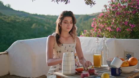 romantic lady cutting fruits at overview terrace closeup. woman eating apple