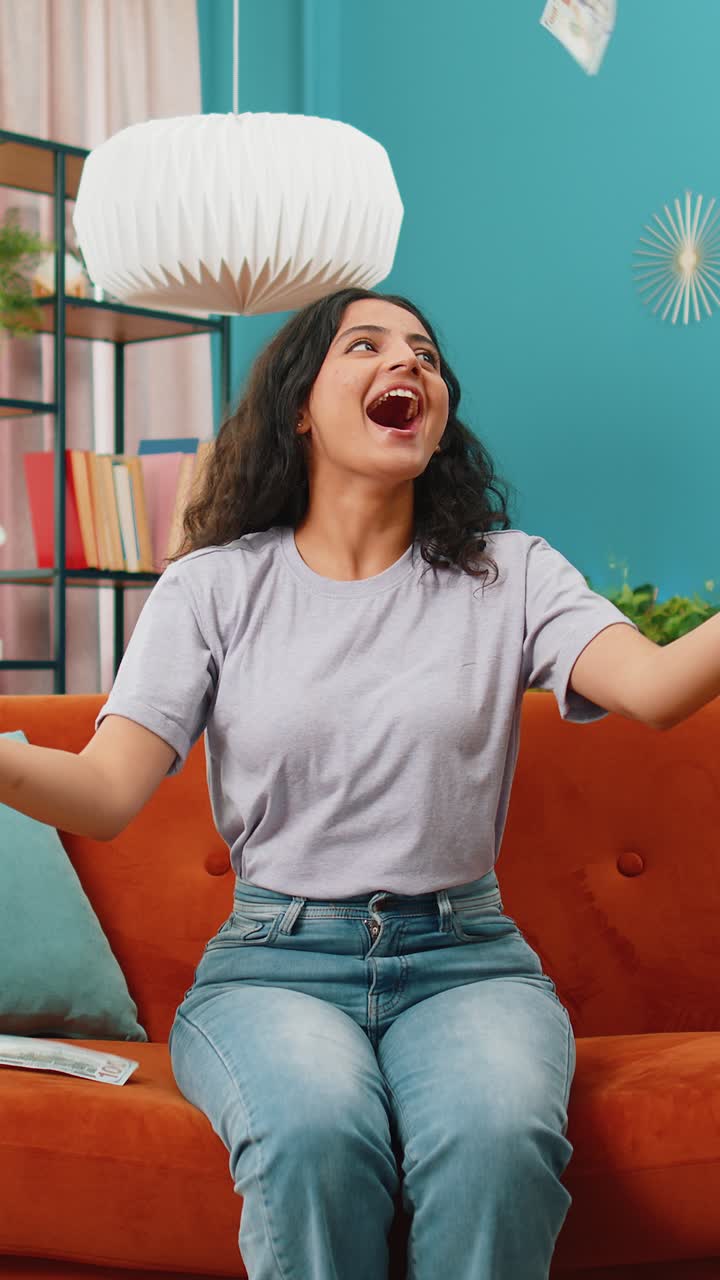 Money cash dollar rain falling on woman celebrating success winning good news lottery jackpot luck