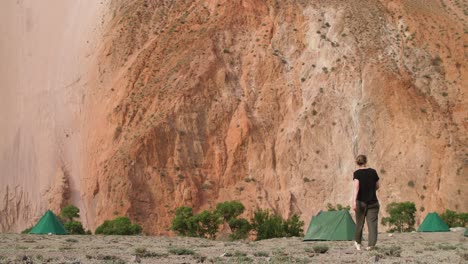 woman walking towards tents