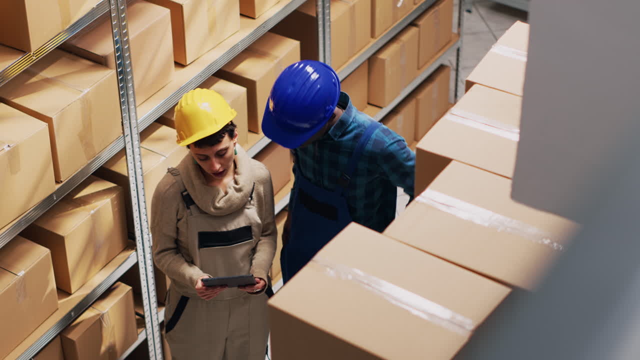 Warehouse worker using tablet to manage inventory