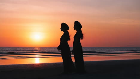 Silhouettes of Two Women on a Beach at Sunset