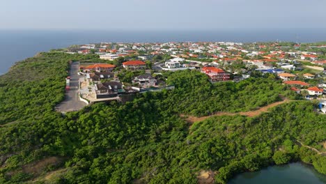 drone ascends to showcase stunning caribbean cliffside neighborhood of vista royal, curacao