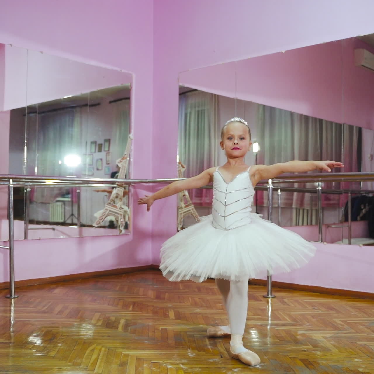 Ballerina dancing in studio in front of mirror. In the ballet hall. A little dancer.