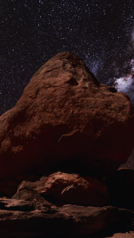 night sky over a rock formation in the desert