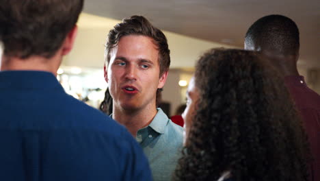 close up of young friends meeting for drinks in bar