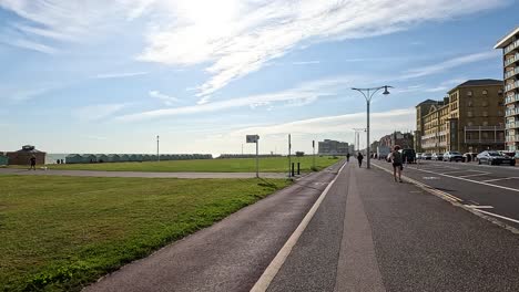 people walking on a sunny brighton footpath