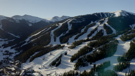 aerial drone copper mountain colorado ikon epic pass winter spring sunny first light sunrise morning sunset half pipe chairlift ski runs center village slowly circle right motion upward