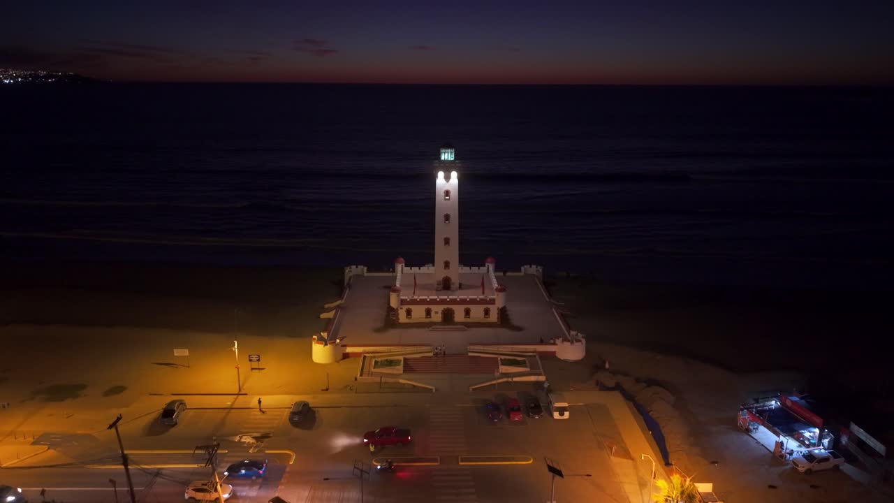 Aerial view toward the illuminated Faro Monumental de La Serena night in Chile