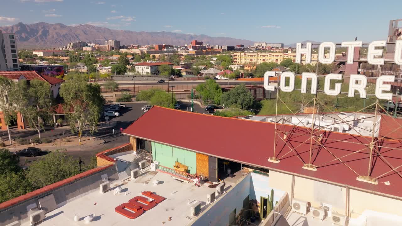 Aerial view of Hotel Congress sign and downtown Tucson with mountains in the background on a sunny day
