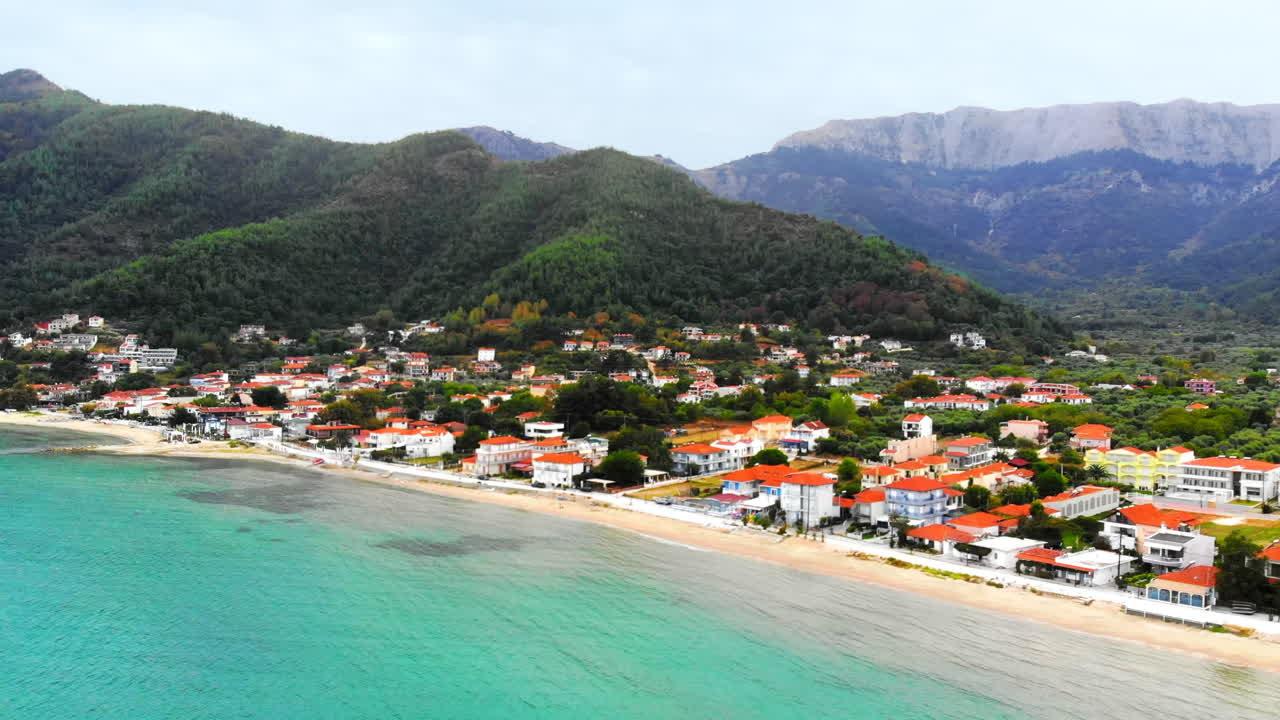 Aerial view of Aegean sea coast of Thassos, buildings, beach, hills on the background, Greece