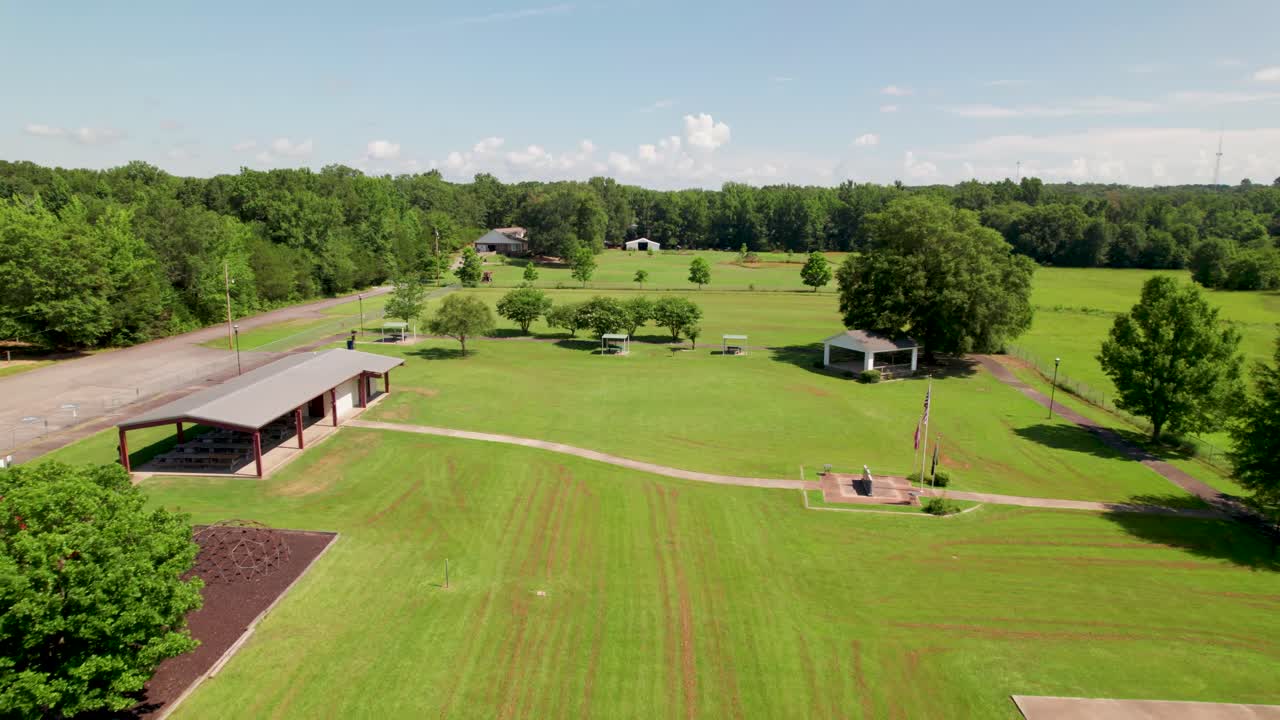 Aerial footage of the Wooster City Park in Wooster Arkansas. Camera flies over the park revealing several park ammenities