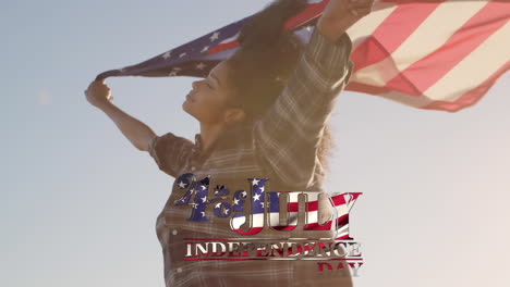 young biracial woman holding us flag with independence date foreground