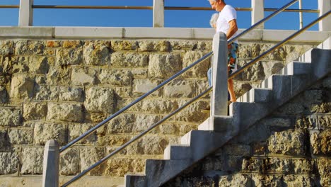 senior couple walking downstairs near beach 4k