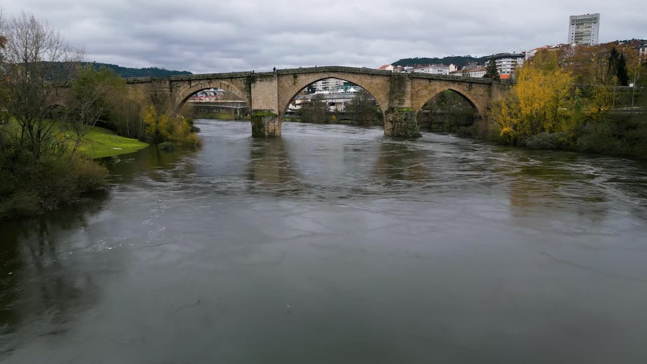 Low dolly push in to Ourense Roman Bridge on Mi&ntilde;o River in Ourense, Galicia, Spain