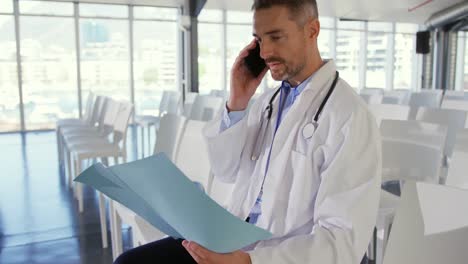 doctor talking on smartphone at a seminar