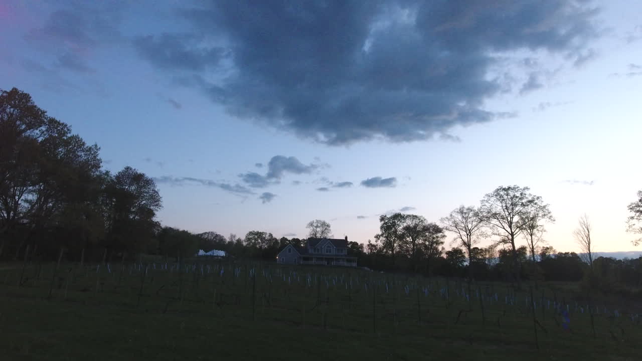 fly in aerial shot of a home in the woods