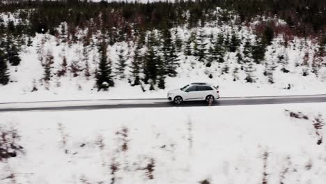 car diving in the snowy highway along the snow-covered forest during winter in slovakia