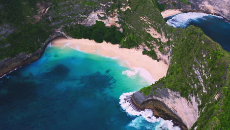 tropical kelingking beach with steep rock cliffs and lagoon, indonesia