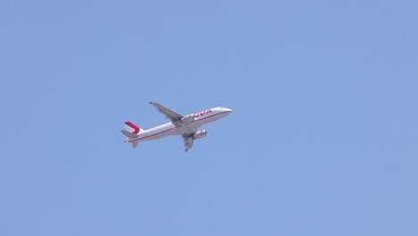 airplane in flight against clear blue sky