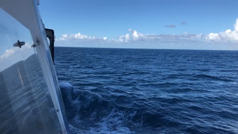 slow motion waves on atlantic ocean sailing with sailboat during a sunny calming relaxing day of summer